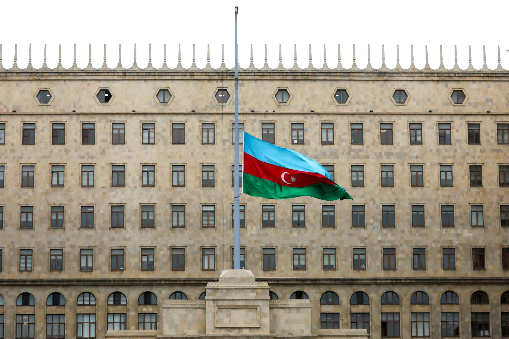 Azerbaijan’s flag, outside government building, at half-staff in memory of air crash victims, Baku, Azerbaijan, Dec. 26, 2024. (AP Photo/Aziz Karimov)